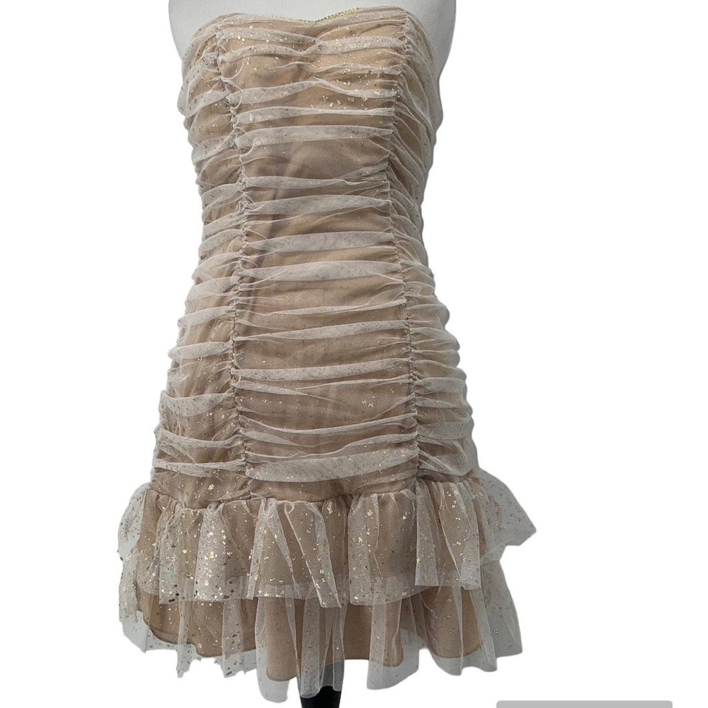 B.Wear strapless gold and cream mini ruffle dress with gold flecks